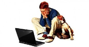 Boy with a dog in front of a laptop