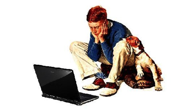 Boy with a dog in front of a laptop