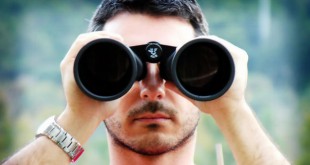 Serious looking man with binoculars - looking for Less Common WordPress SEO Tips