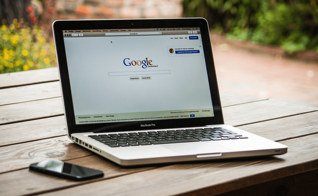 A laptop displaying the Google home page.