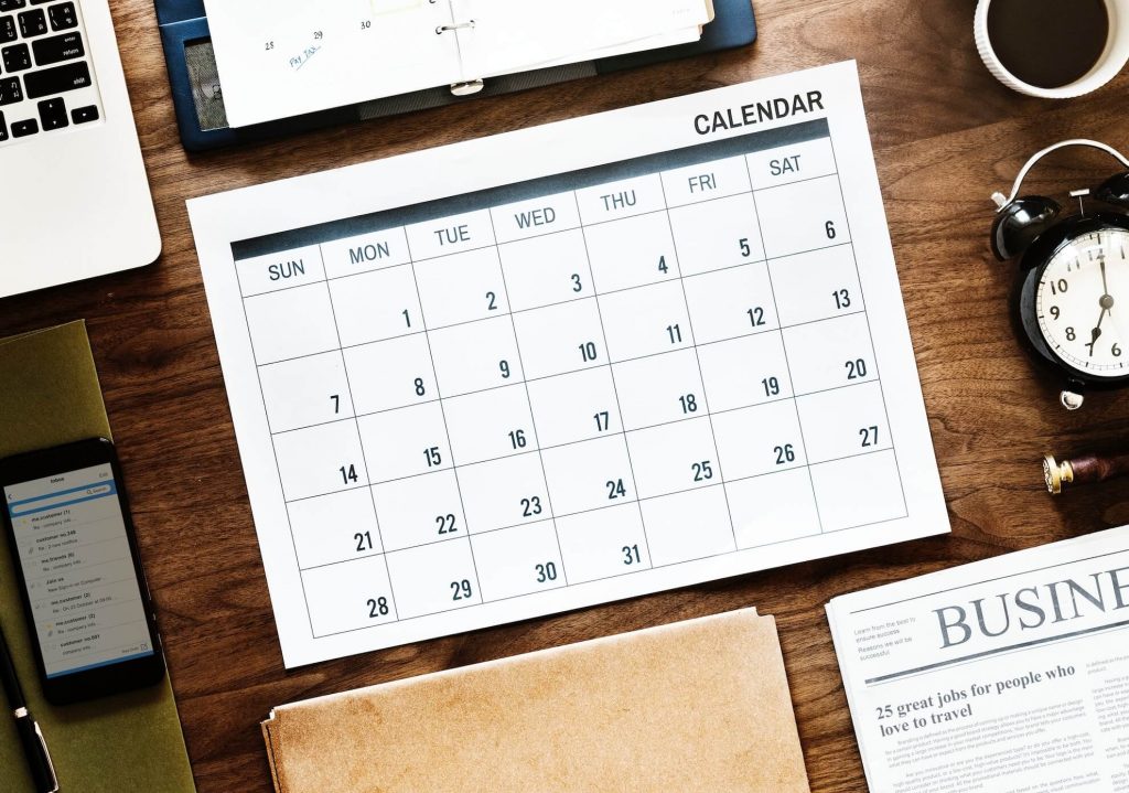 A calendar sitting on a desk.