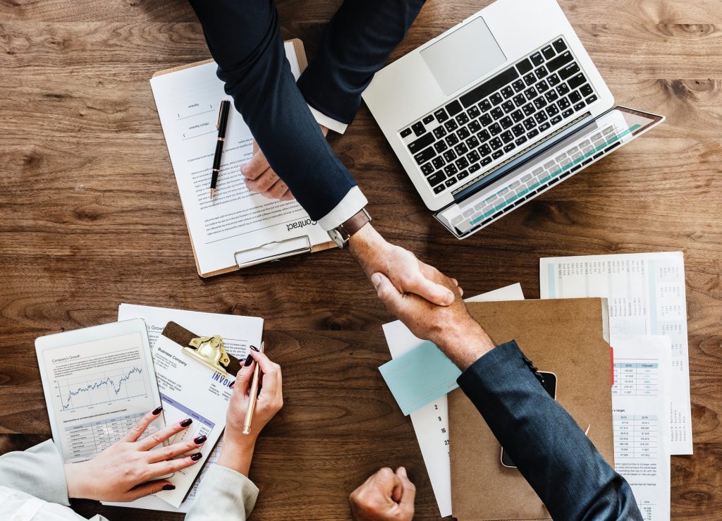 A handshake across a desk.