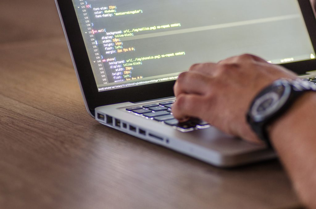 Person coding on a laptop.