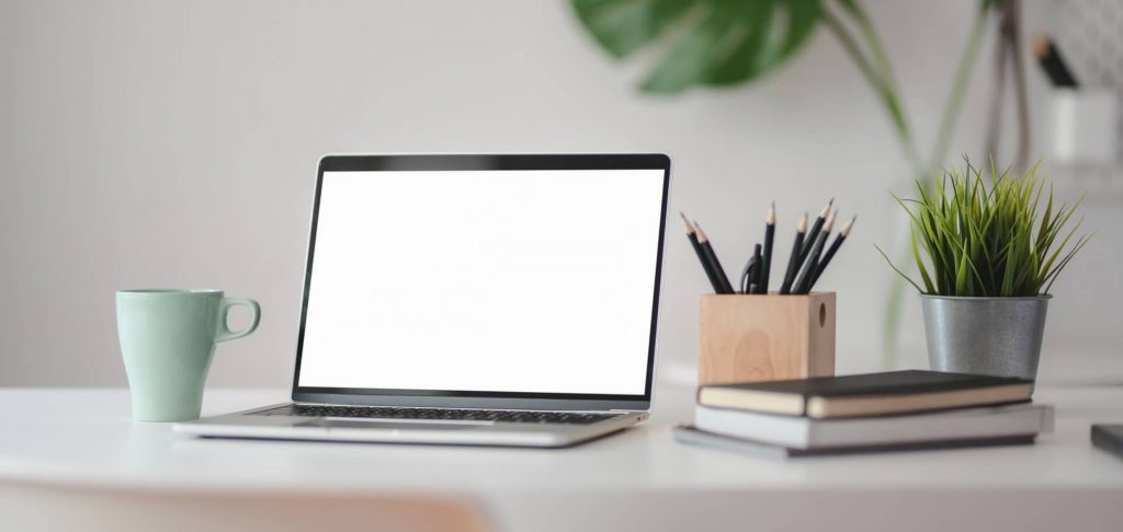 A laptop with a blank white screen.