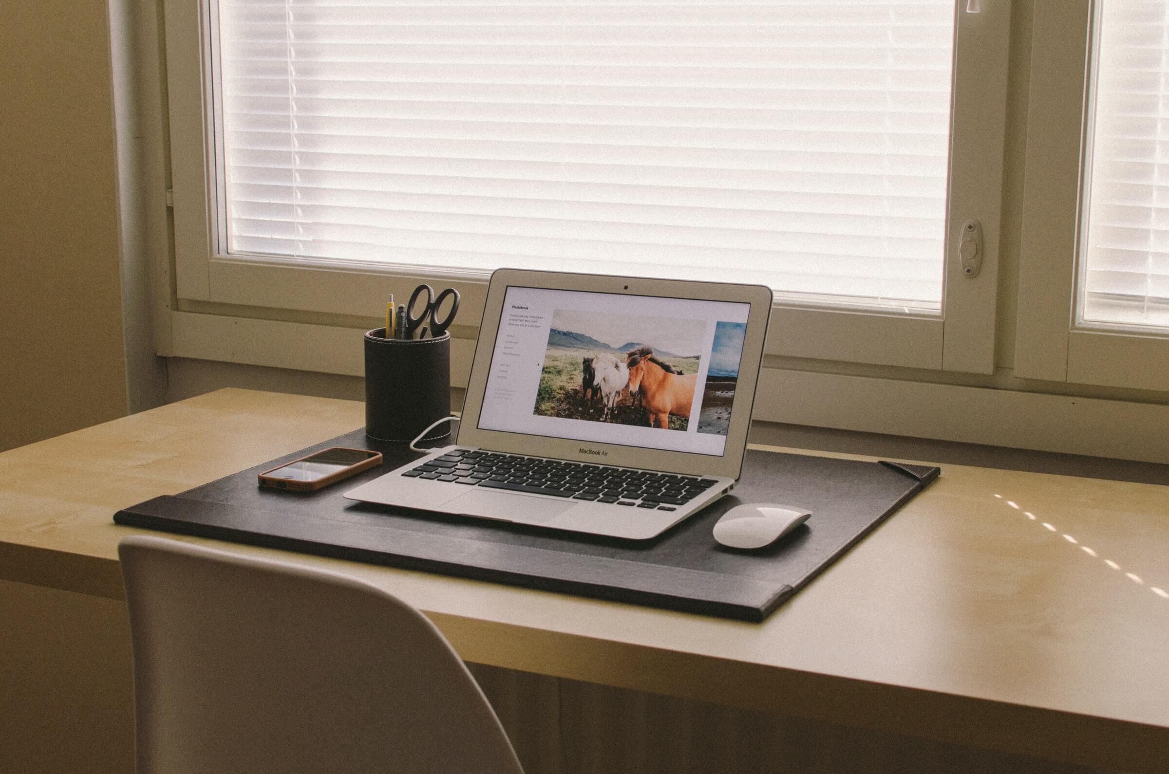 Laptop and mouse on a desk.