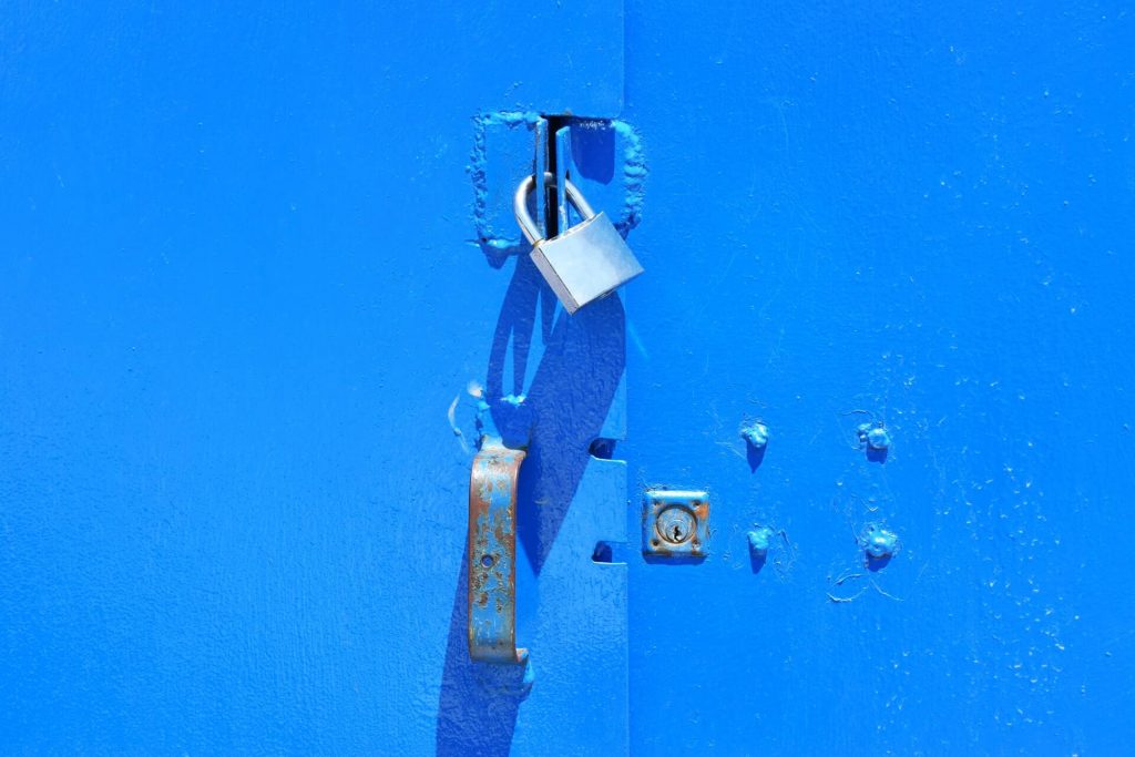 A padlock on a blue door.