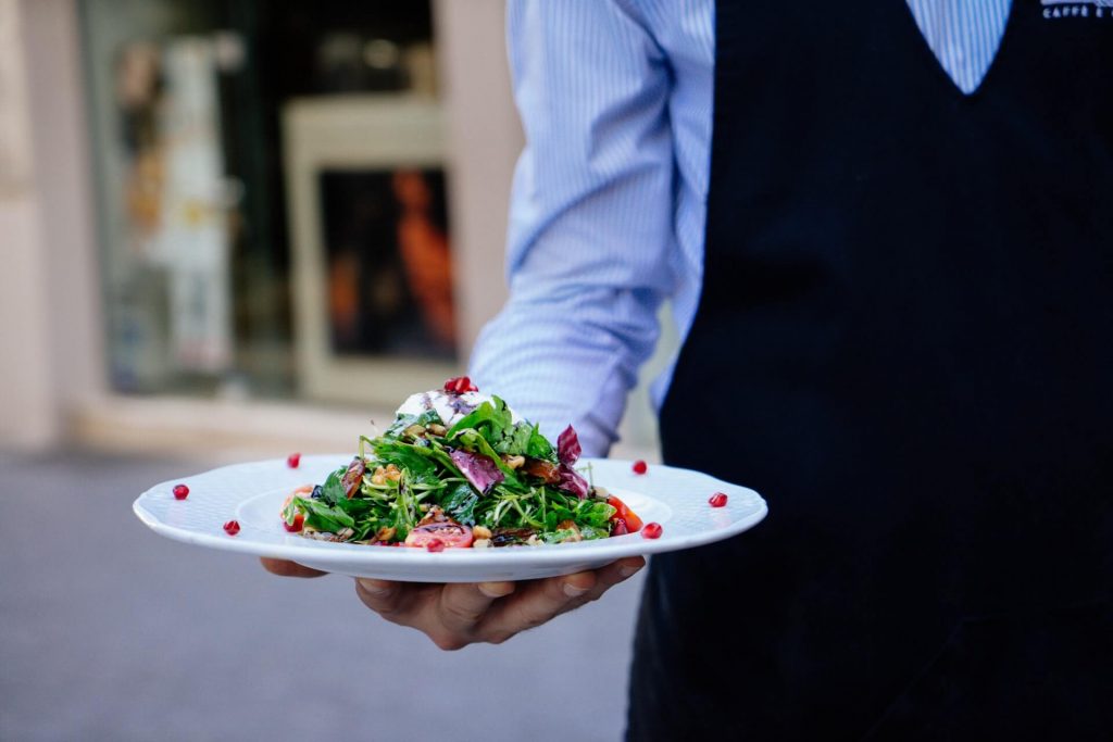 A waiter holding a plate.