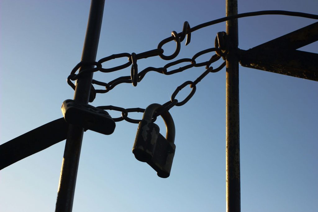 A chainlink fence, with a padlock.