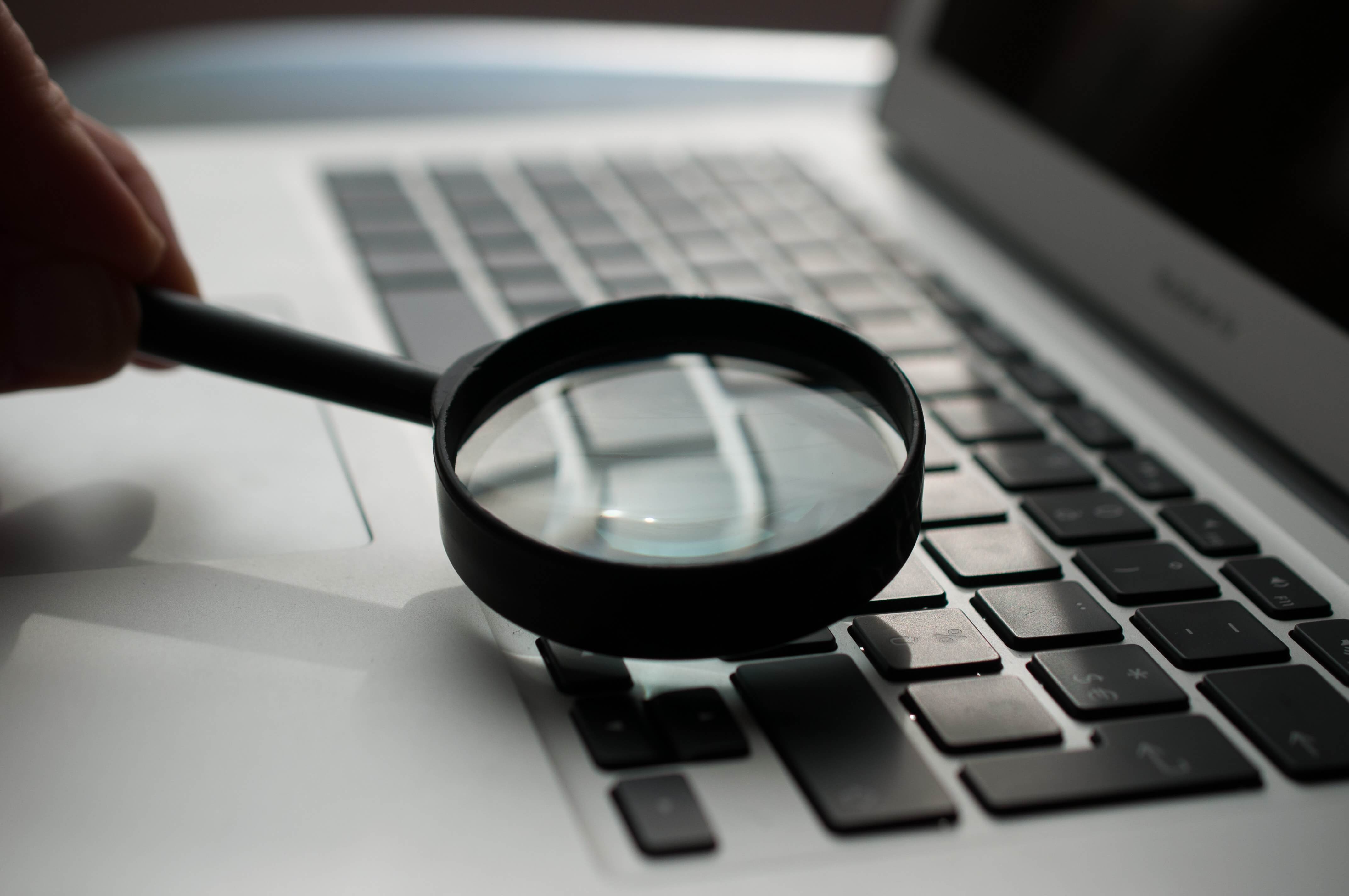 Magnifying glass on a laptop.