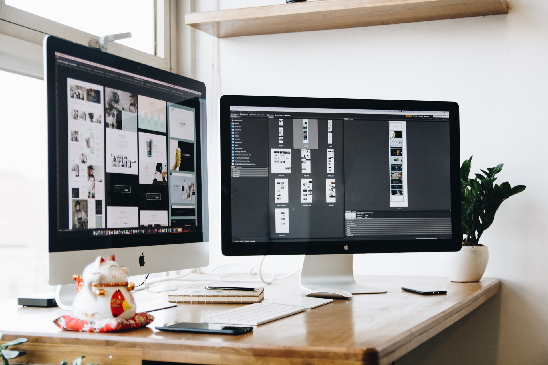 A desk with two computer monitors.