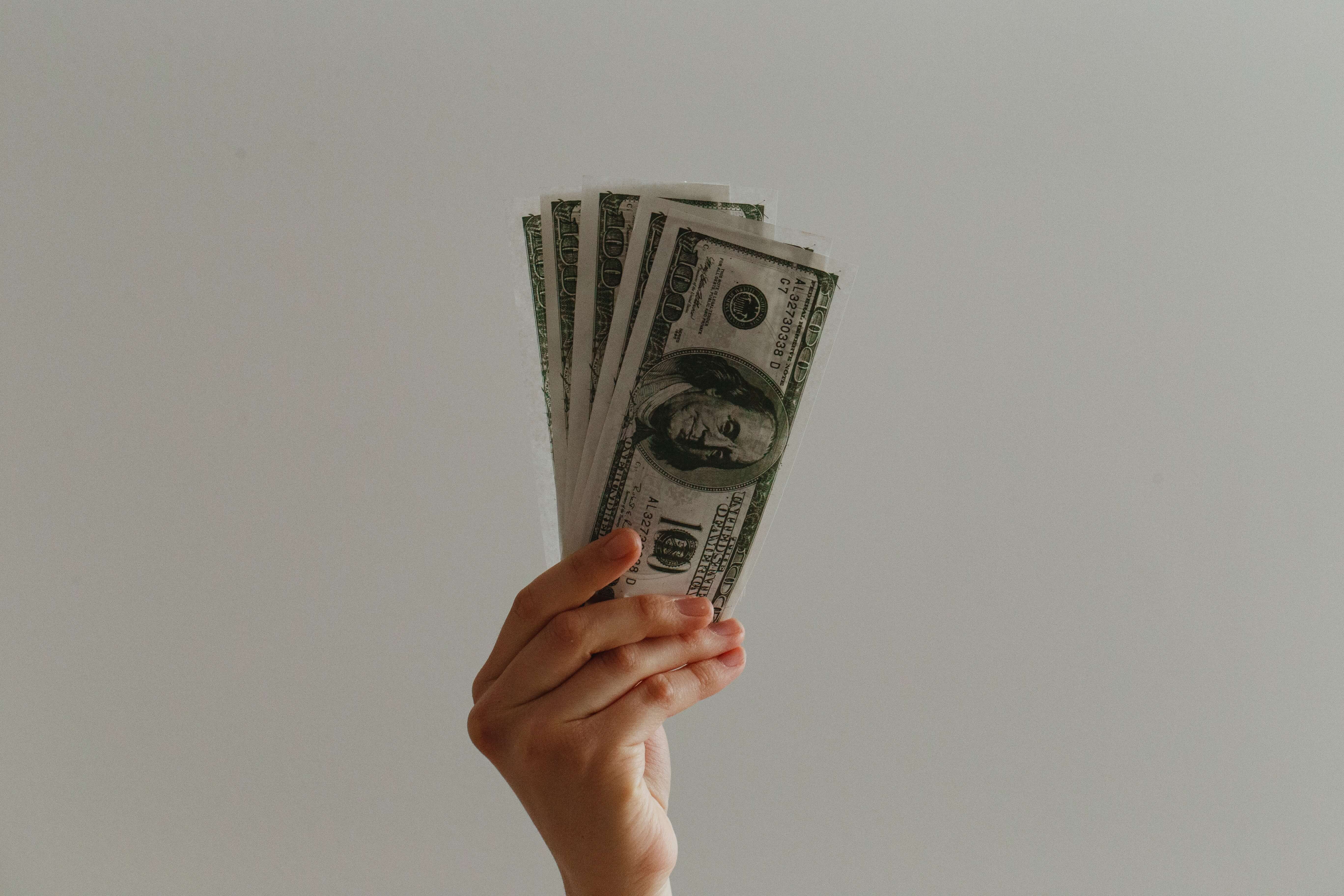 A hand holding cash.