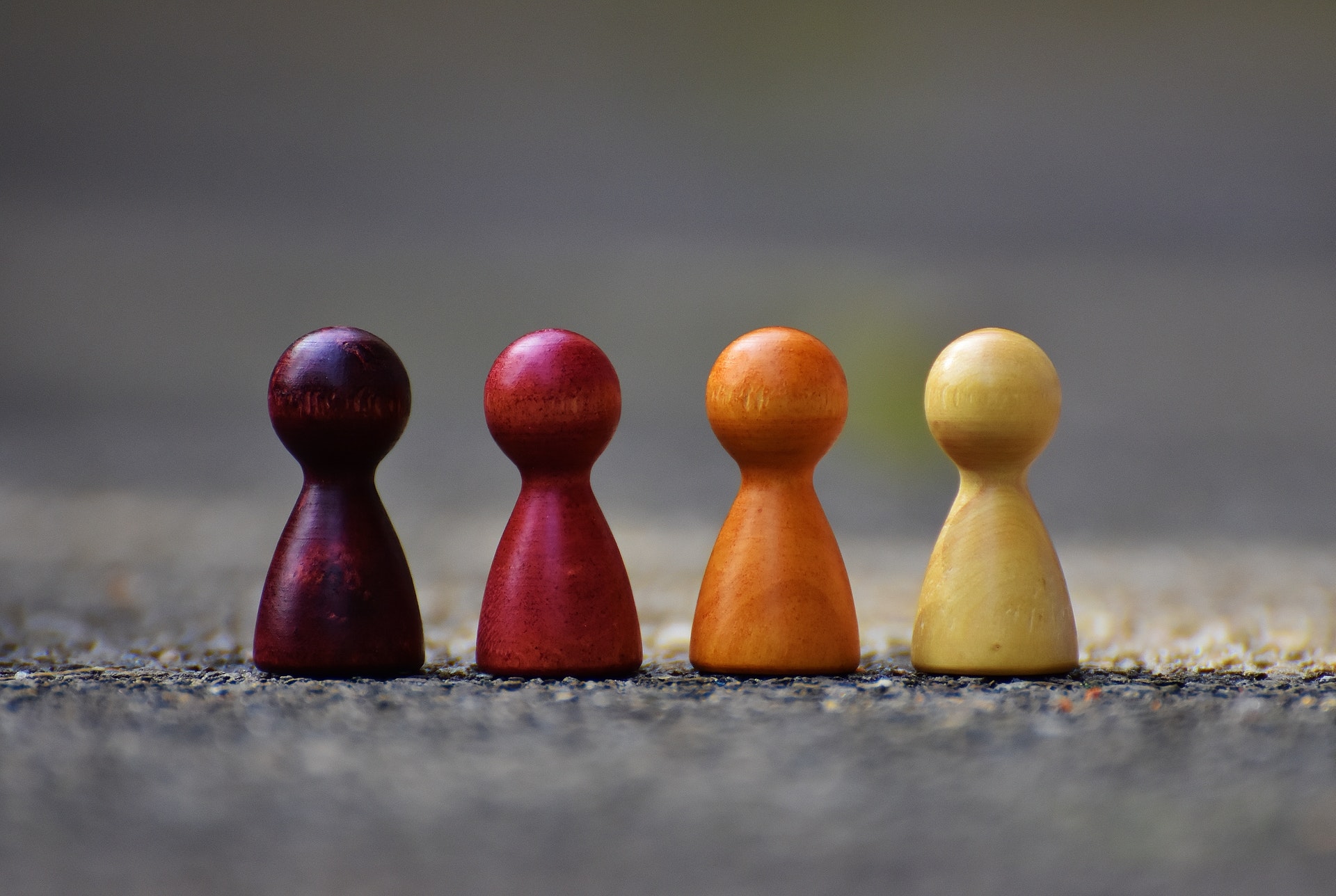 Four differently colored chess pieces together.