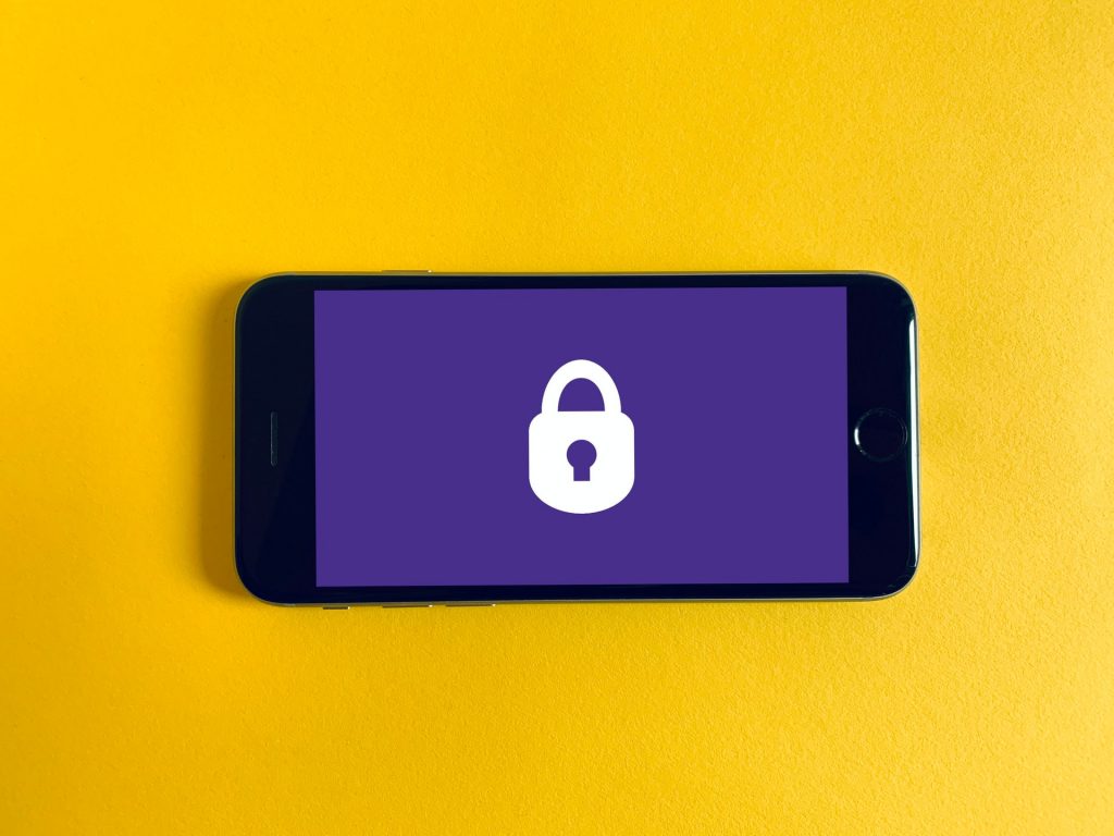 A cellphone with a padlock on the screen.