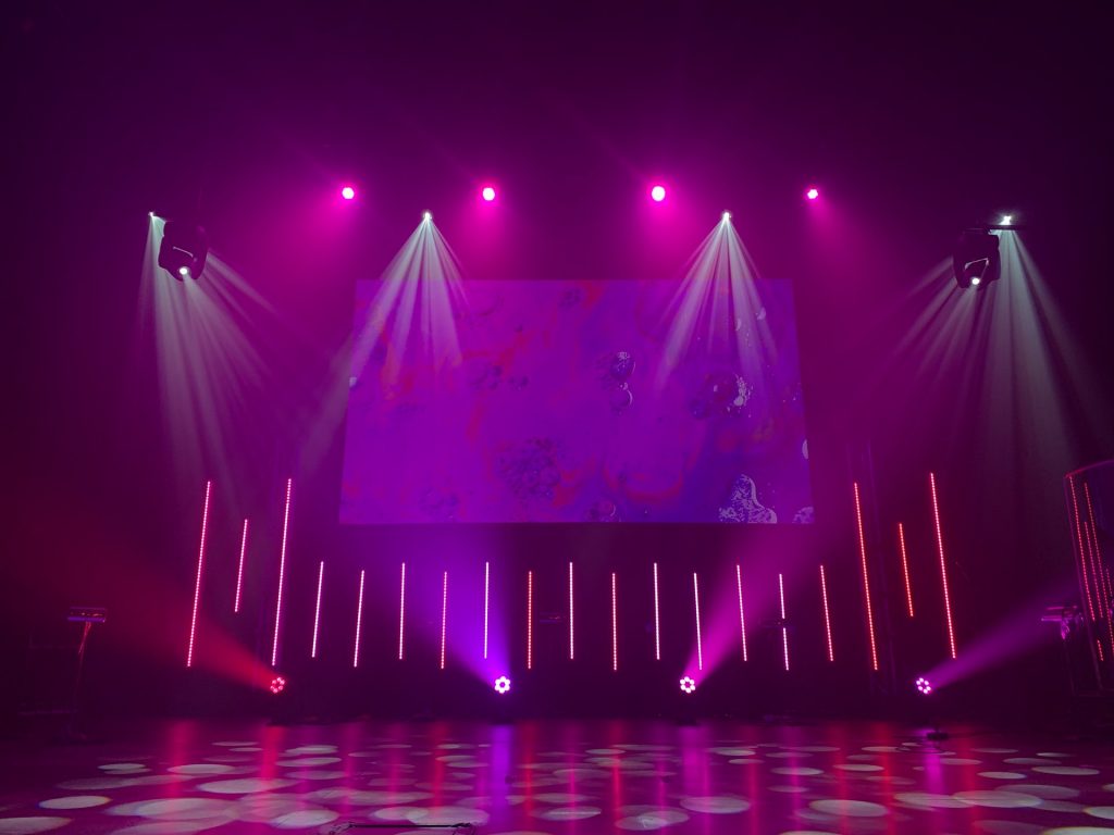 A stage with purple lights.